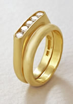 Five diamond channel set engagement ring and wedding band in 18K yellow gold